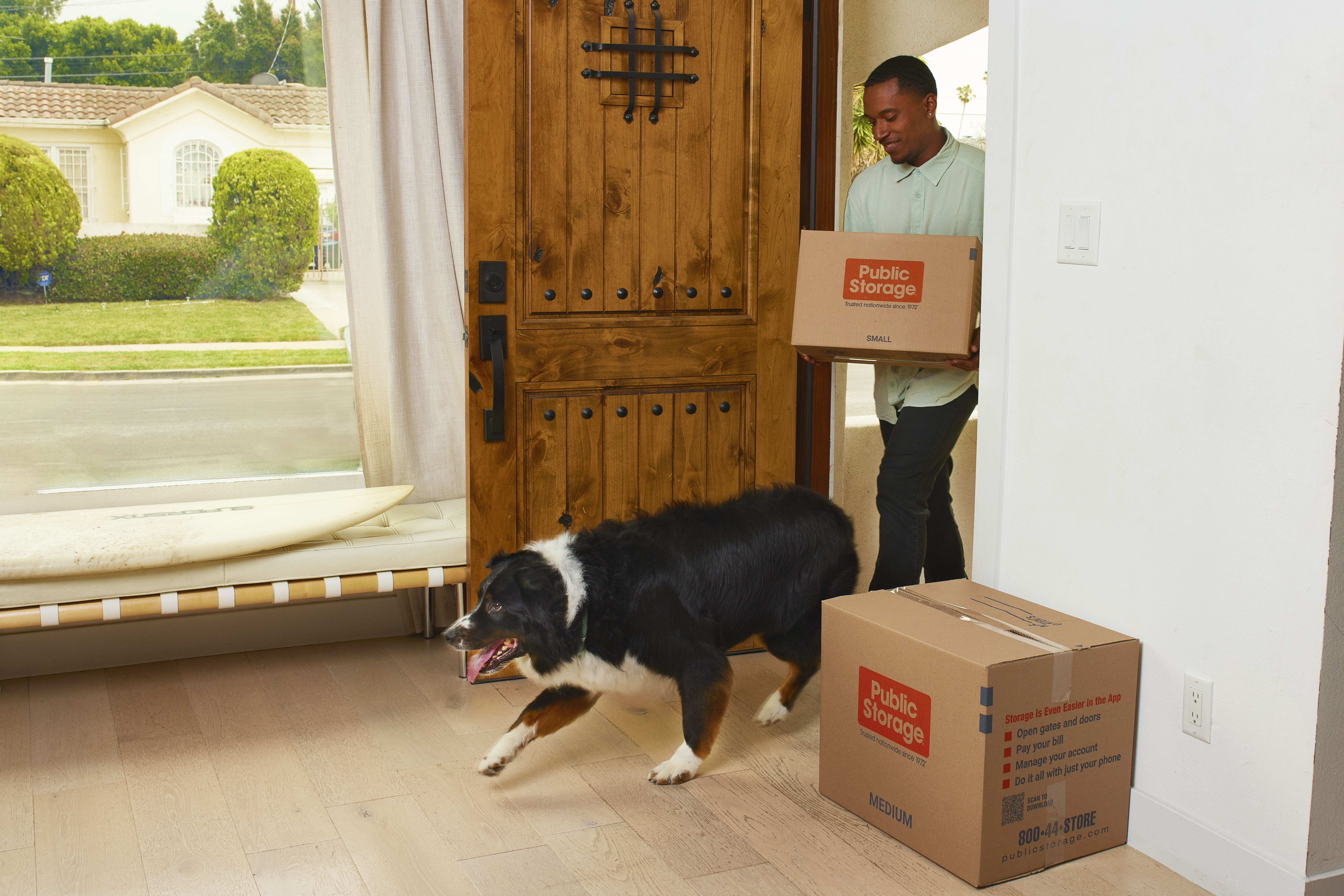 dog walking into new home behind owner who used fur friendly moving tips